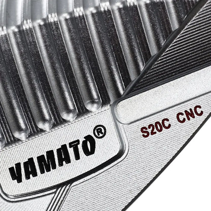 Close-up of Yamato wedge back showing engraved brand logo on polished surface