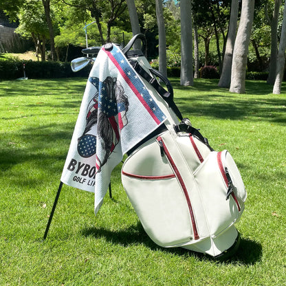 Yamato magnetic golf towel with American flag design attached to golf cart, showing strong magnet clip in use.